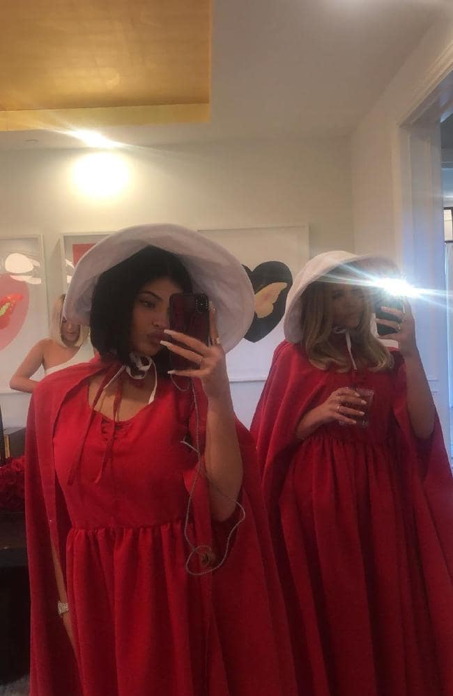 Kylie Jenner (left) in her Handmaid's Tale outfit.
