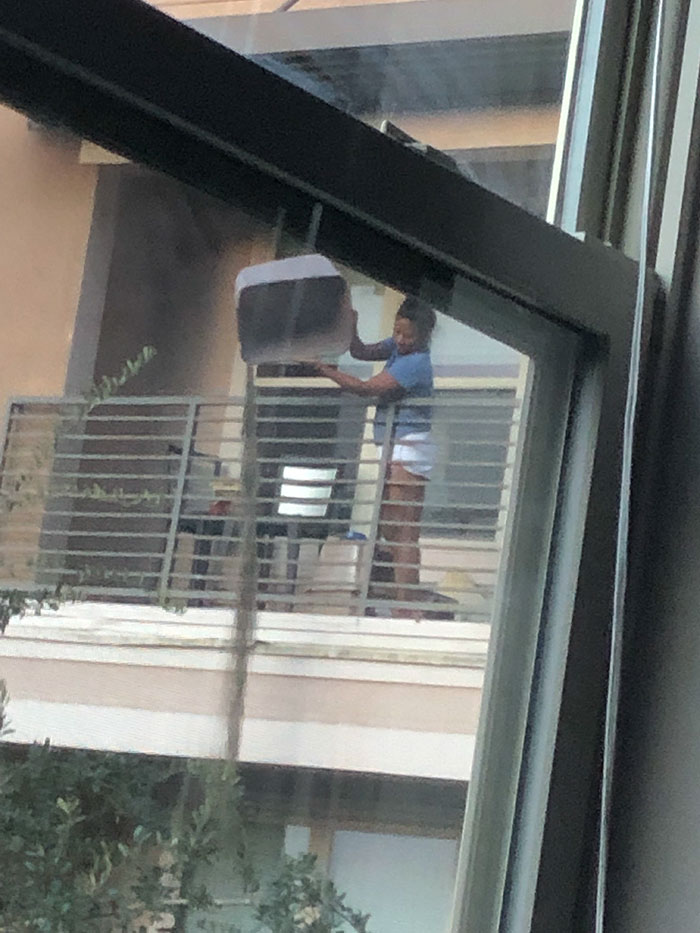 Dumping A Litter Box Off The Top Floor Balcony Of A Pet-Free Apartment Building